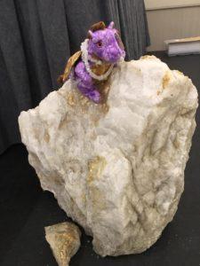 Plush purple dragon atop Azeztulite centerpiece (on the side of the stage).